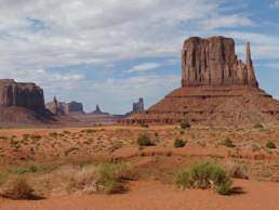 brown rock formation under white clouds during daytime